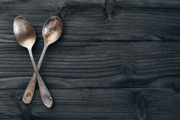 Old cutlery On a wooden background Top view Free space for text