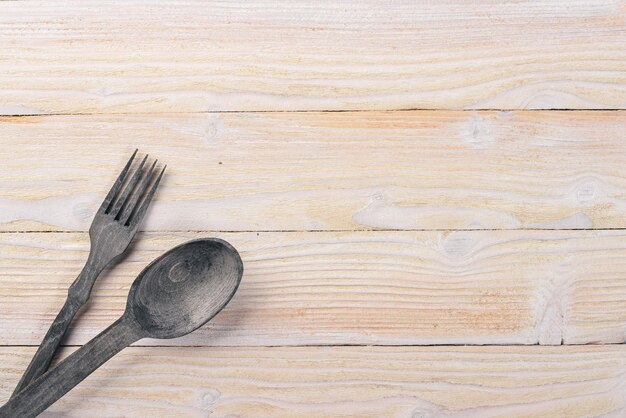 Old cutlery On a wooden background Top view Free space for text