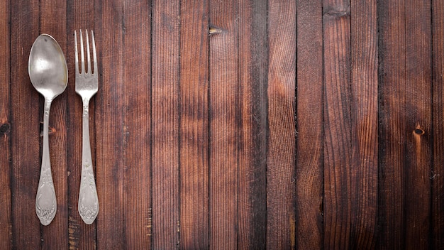 Old cutlery On Wooden background Top view