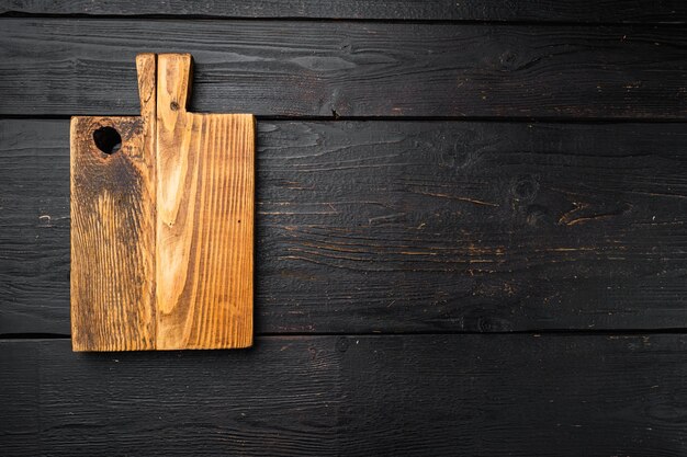 Old cutting board set, top view flat lay , with copy space for text or food, on black wooden table background