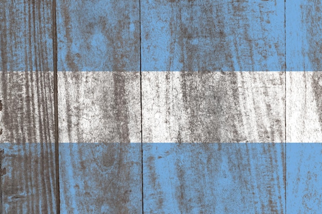 Old damaged argentina flag painted on a distressed wooden\
background