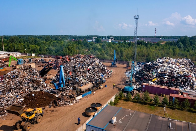 Old damaged cars on the junkyard waiting for recycling