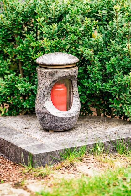 Photo old damaged grave lantern on a gravestone