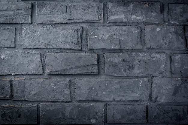 Old dark grey brick wall, surface