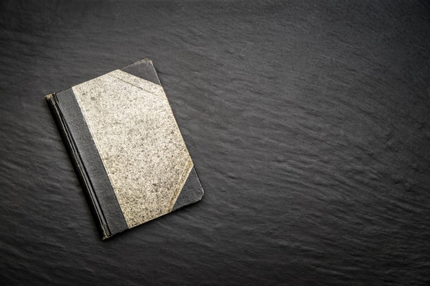 Old diary on black stone