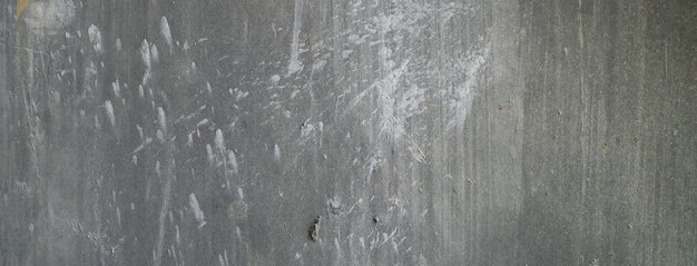 Old dirty concrete wall as a background Gray cement plaster Wall texture for background Brush scratches on the wall