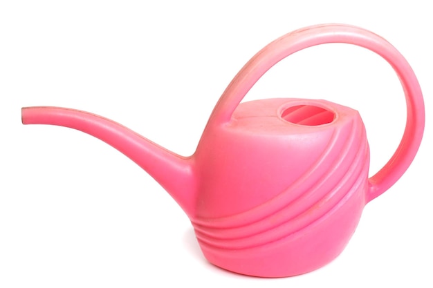 Old dirty pink plastic watering can isolated