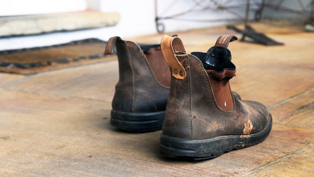 Old Dirty Working Boots In The Room On The Floor