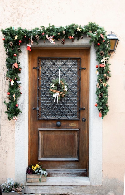 Old door decorated for christmas with garland