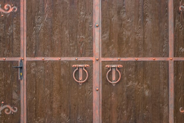 The Old door knocker. The wooden texture.