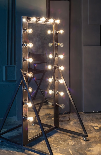 Old dressing room full length mirror with light bulbs.