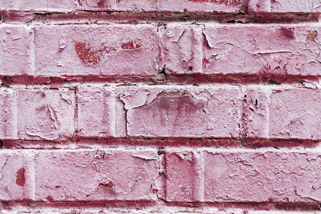 Old dusty brick wall with peeling paint texture