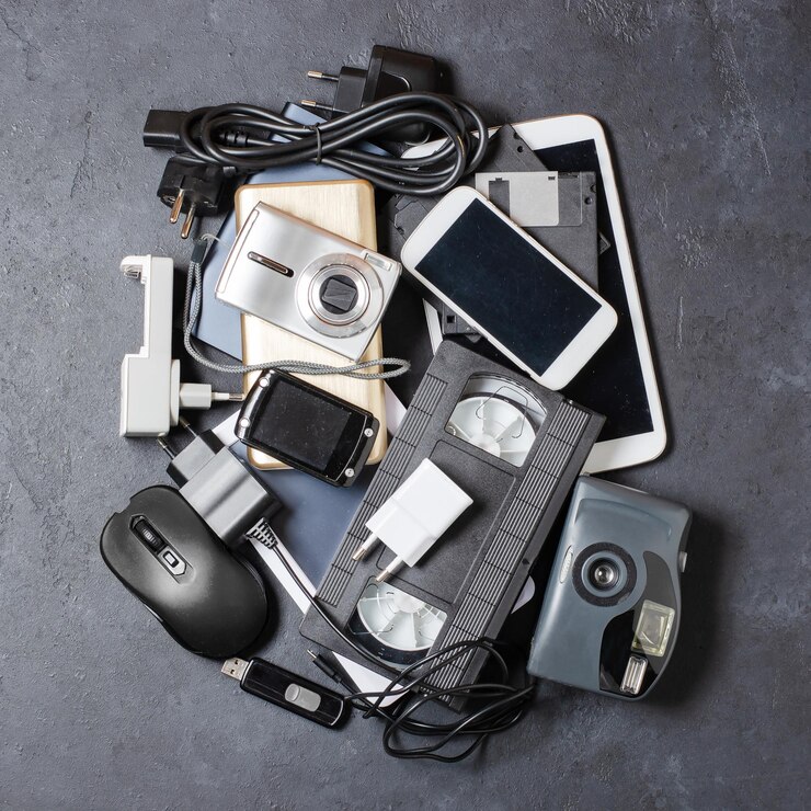 Old electronic devices on a dark background The concept of recycling and disposal of electronic waste
