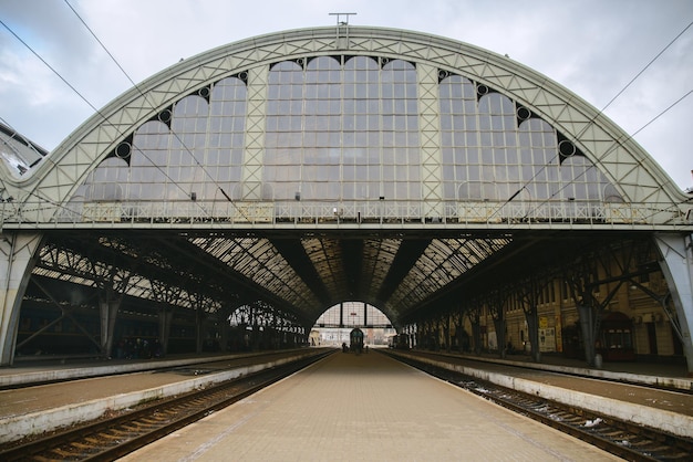Old empty railway station with metal arch travel concept