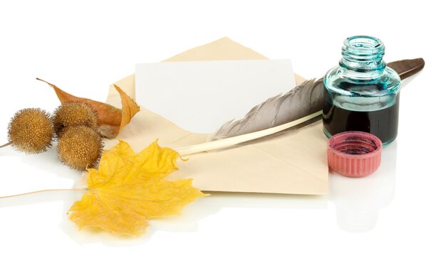 Old envelope with blank paper and autumn leafs isolated on white