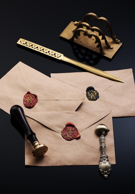 Old envelopes with red wax seal, letter opener and letter\
holder. vintage writing accessories