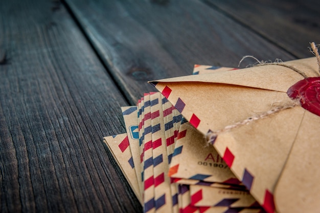 Old envelopes with a wax stamp on a wooden table