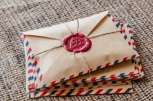 Old envelopes with a wax stamp on a wooden table