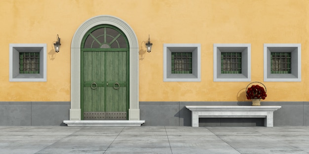 old facade with  wooden doorway,windows and bench 