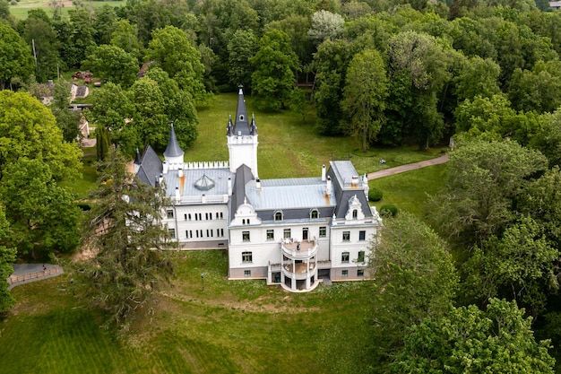 Old fairytale palace in Stameriena Latvia Summer time aerial drone view