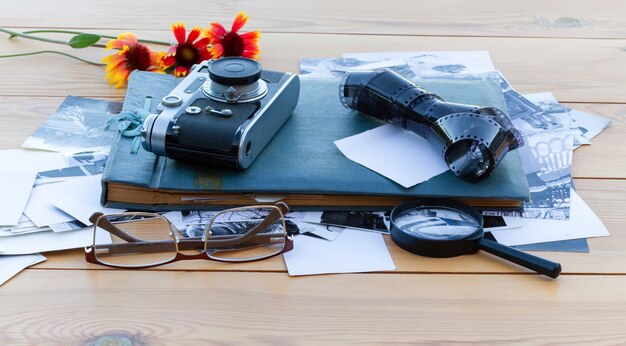 Old family photo album on a wooden table.