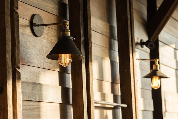 old-fashion lamp hanging on wooden wall