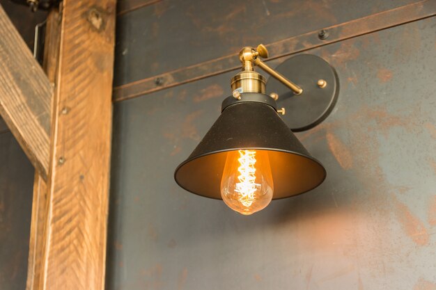 old-fashion lamp hanging on wooden wall