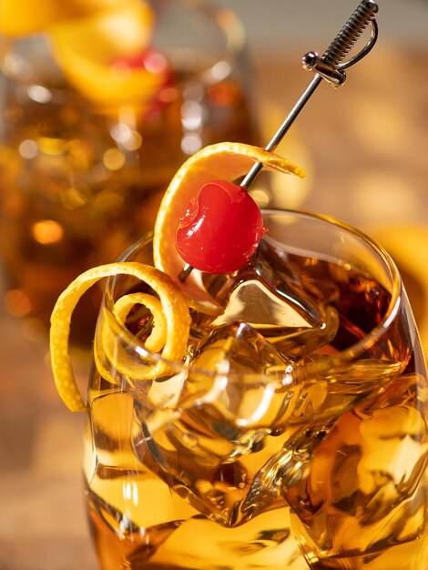 Old fashioned cocktail served on the rocks with orange peel garnish