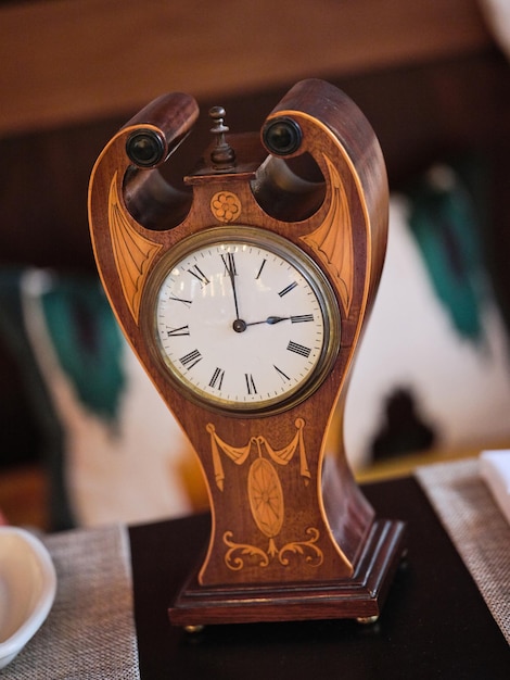 Old fashioned vintage clock on table