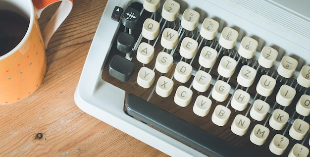 Old fashioned vintage typewriter on wood desk