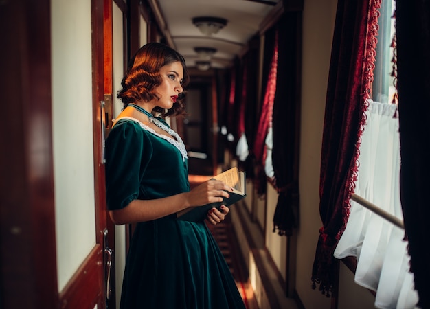 Old-fashioned woman travels, retro train