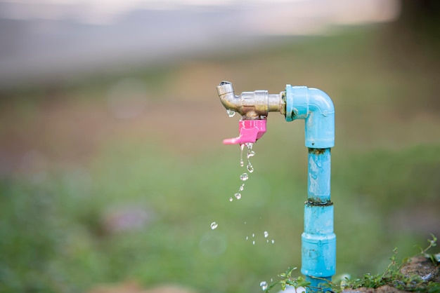 Old faucet in nature background