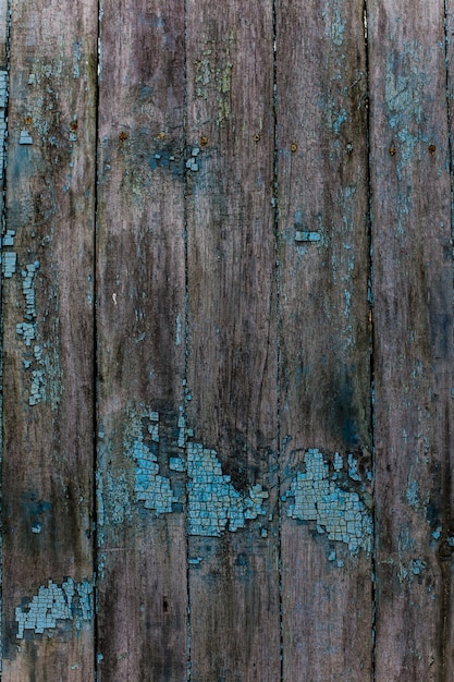 Old fence with paint residues Cracked blue paint