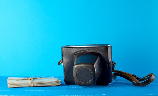 Old film camera in a brown leather case 