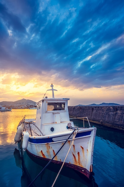 Old fishing boat in port of Naousa on sunset. Paros lsland, Greece