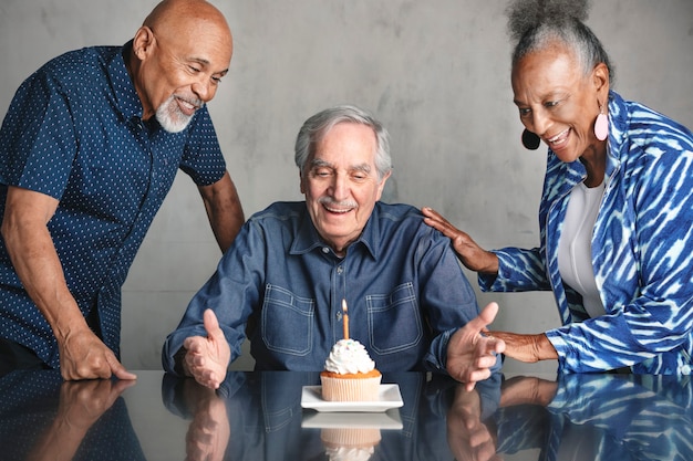 Old friends celebrating a birthday with cake