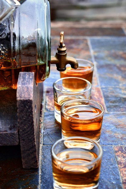 Photo old glass barrel on stone table and wooden background.