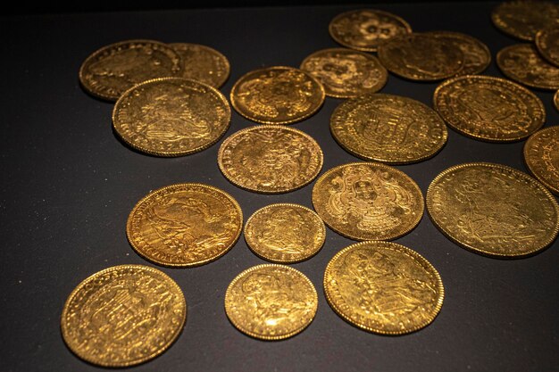 Photo old gold coins on black background