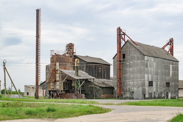 Old grain dryer on the farm against the sky