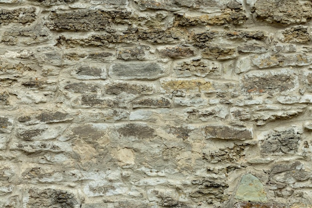 Старая серая каменная стена. Каменный фон из серых старых камней.