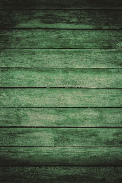 Foto vecchie plance di legno squallide verdi con vernice di colore incrinato