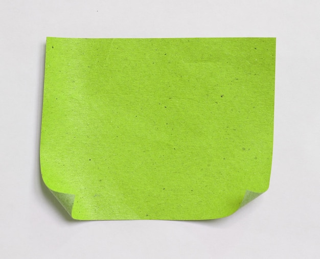 写真 白い背景の上の古い緑の涙紙