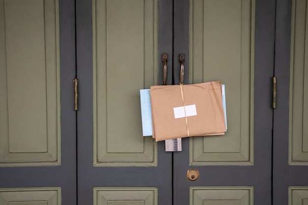 Old  green vintage front door with envelope