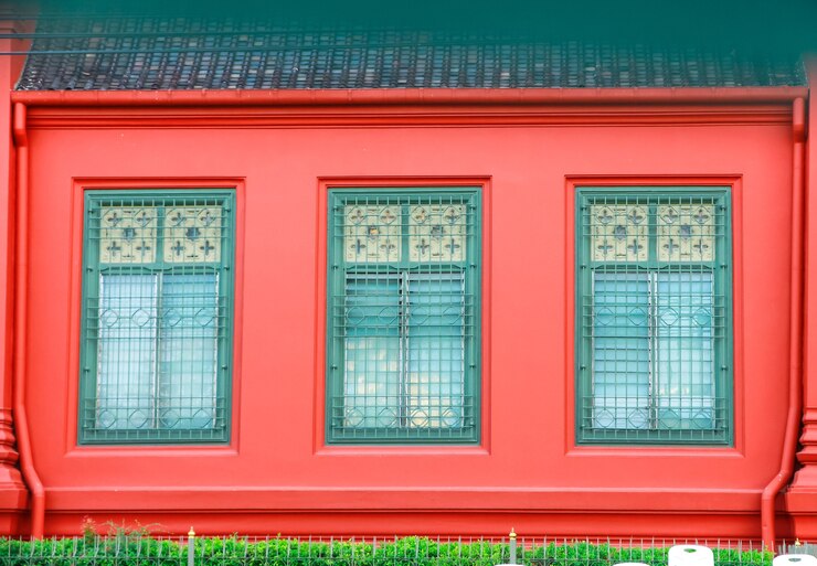 Photo old green window, on red building. 