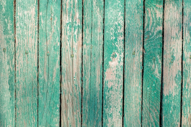 Old green wooden fence. painted boards. vintage wood texture.