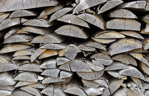 Old grey boards are stacked on top of each other.