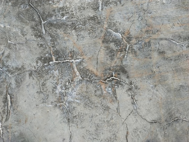 Old grunge crack grey concrete or cement wall texture background with dry moss