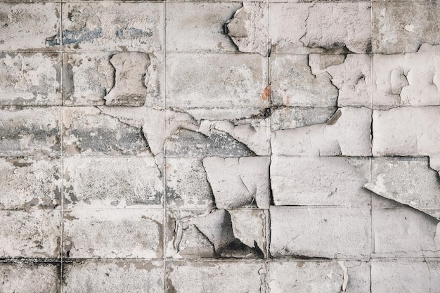 Old grunge peeling paint brick block dirty dusty aged weathered wall texture pattern for construction background