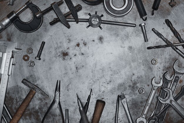 Old hand tools on metal grunge surface