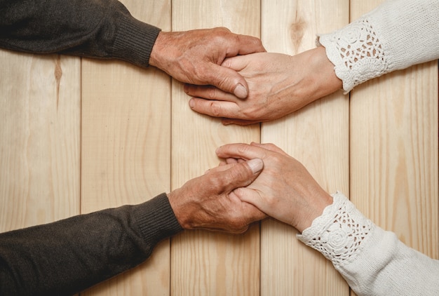 Foto vecchie mani di una coppia di anziani insieme, tenendosi per mano